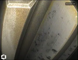 Hardened gear tooth with visible surface indentations caused by high contact stress